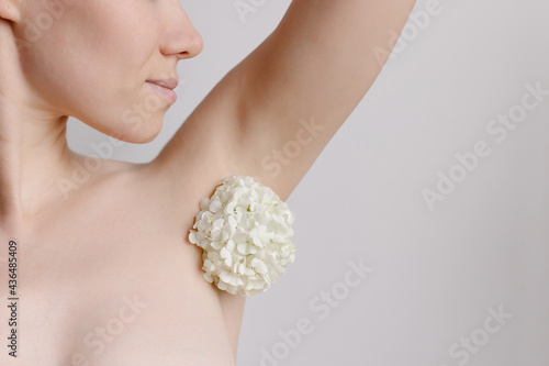 Women's armpit with hair in form of flowers. Refusal of depilation. Love for your body. Taking care yourself. Feminism. Trend. Natural clean skin smells good. unshaved photo