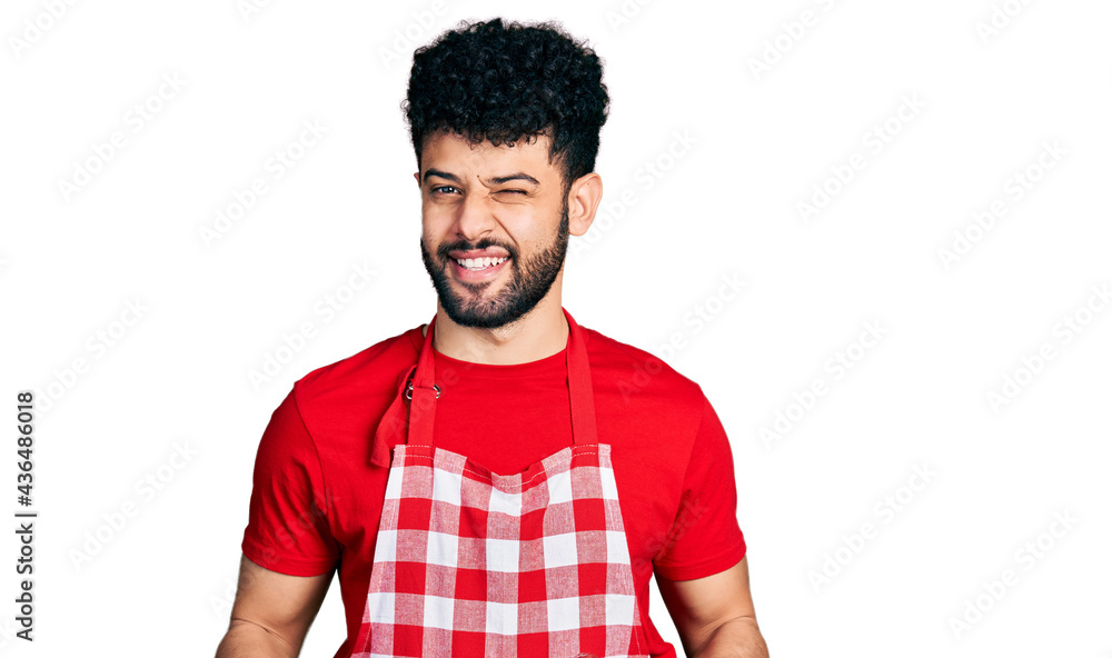 Young arab man with beard holding board with raw meat winking looking at the camera with sexy expression, cheerful and happy face. Young arab man with beard holding board with raw meat winking looking at the camera with sexy expression, cheerful and happy face.