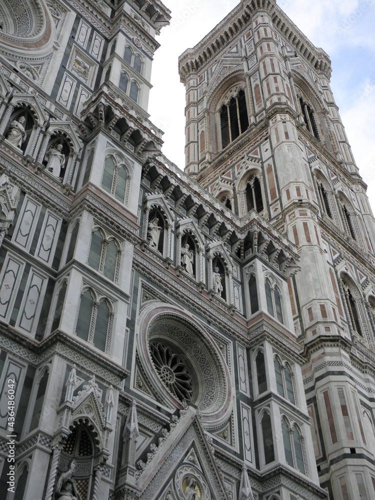 Bell tower and adjacent church of Santa Maria del Fiore. with intricate designs and miniature sculptures.