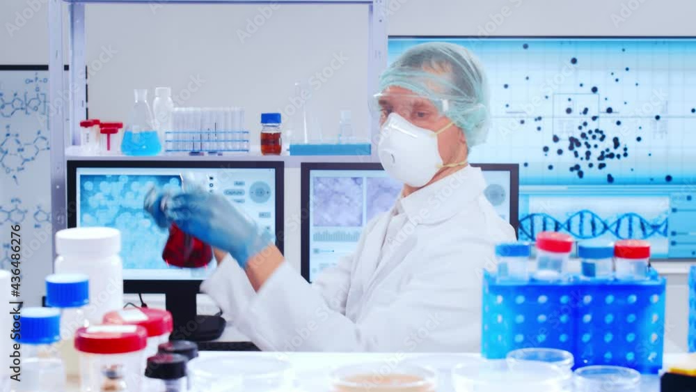 Professional scientist is working on a vaccine in a modern scientific research laboratory. Genetic engineer workplace. Future technology and science. Professional scientist is working on a vaccine in a modern scientific research laboratory. Genetic engineer workplace. Future technology and science.