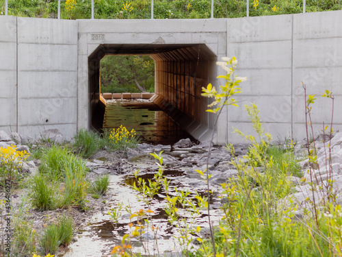 Slika na platnu Selective focus on large concrete stream culvert below city road