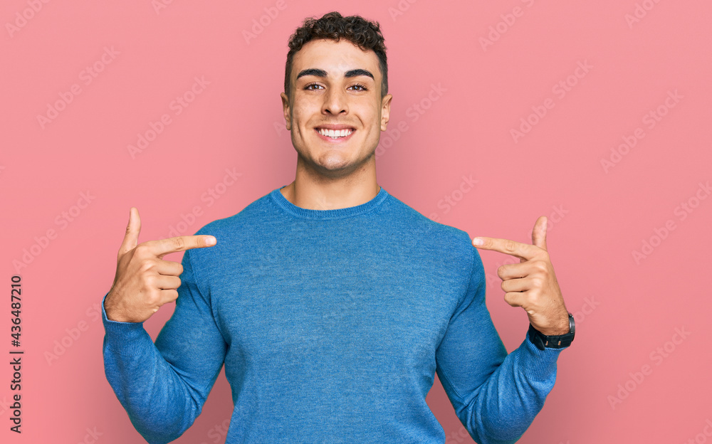 Hispanic young man wearing casual clothes looking confident with smile on face, pointing oneself with fingers proud and happy. Hispanic young man wearing casual clothes looking confident with smile on face, pointing oneself with fingers proud and happy.