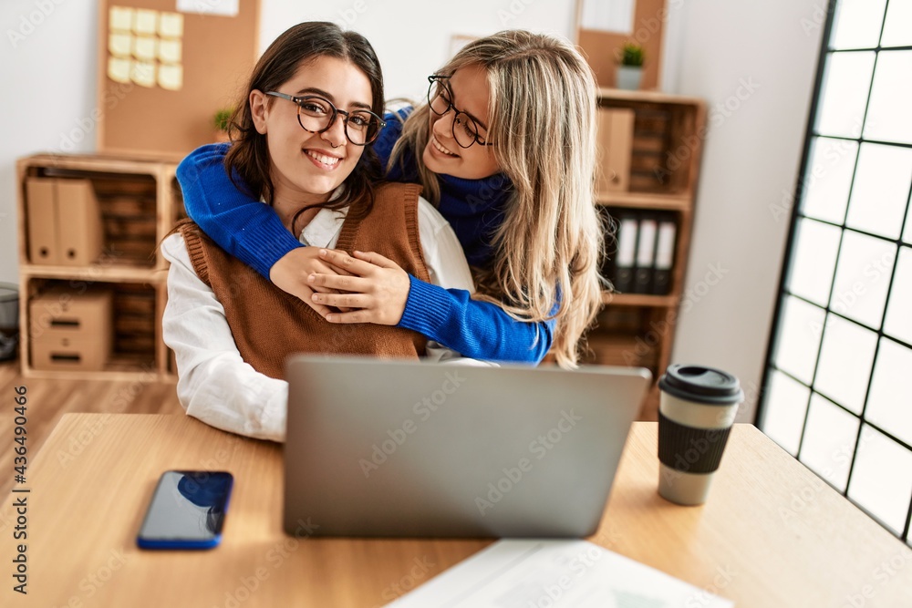 Two business workers woman smiling happy working at the office. Two business workers woman smiling happy working at the office.