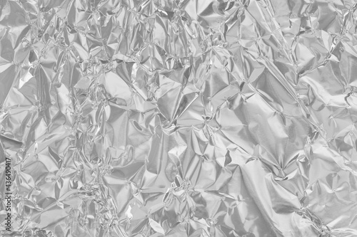Shiny silver foil texture background, pattern of wrapping paper with crumpled and wavy.