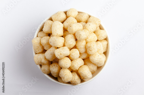 Close up of Cheese Potato Puff Snacks ball and buds, Popular Ready to eat crunchy and puffed snacks buds, cheesy salty pale-yellow color over white background