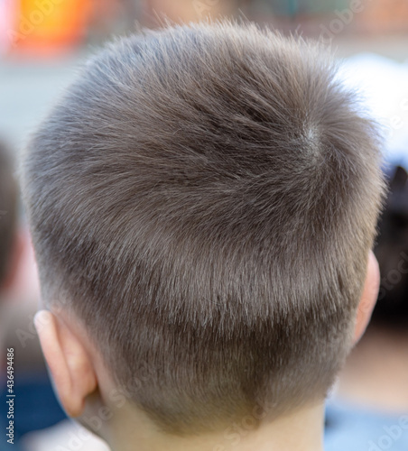 A beautiful haircut on the boy's head.