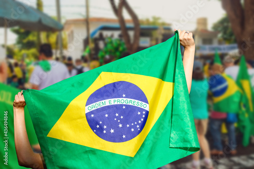 Man holding flag at street demonstration against corruption in Brazil. Concept democracy image with space text. photo