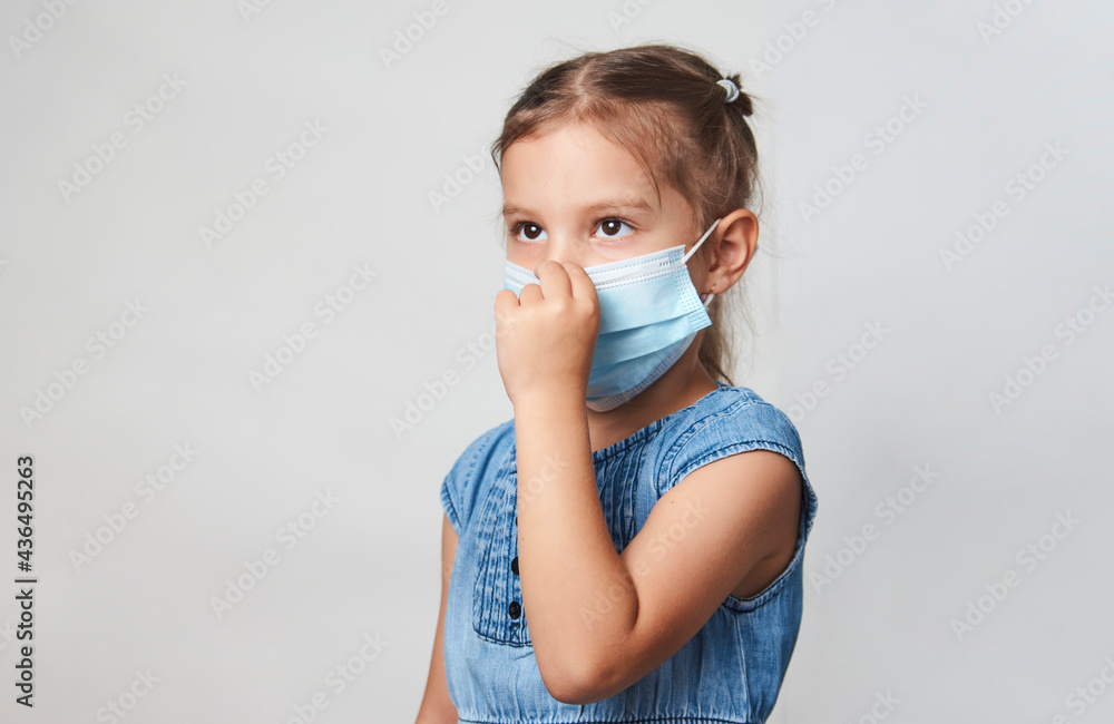 Little girl wearing face mask on a white background Little girl wearing face mask on a white background