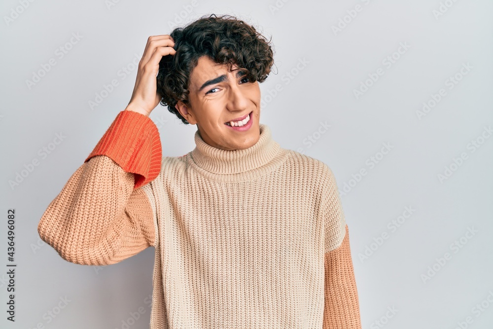 Hispanic young man wearing casual winter sweater confuse and wonder about question. uncertain with doubt, thinking with hand on head. pensive concept. Hispanic young man wearing casual winter sweater confuse and wonder about question. uncertain with doubt, thinking with hand on head. pensive concept.