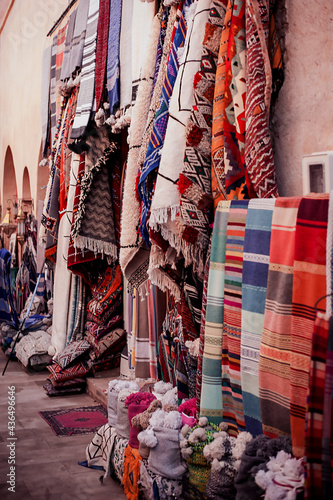 sale of traditional bright colored textiles and fabrics on the street market in the old town in the Middle East of Morocco © Alevtina