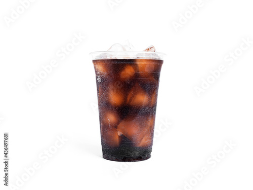 Soda with ice in a transparent plastic glass isolated on a white background.