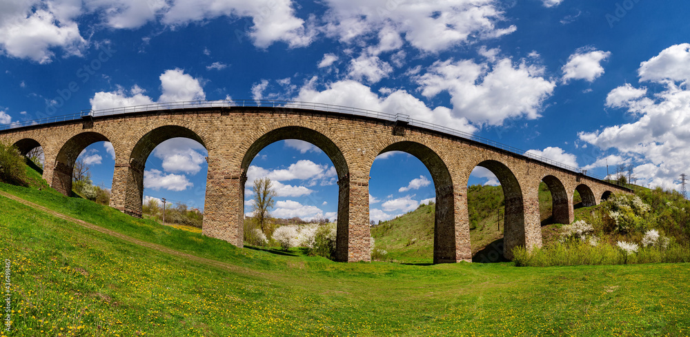 Old railway stone viaduct in the spring in sunny day.