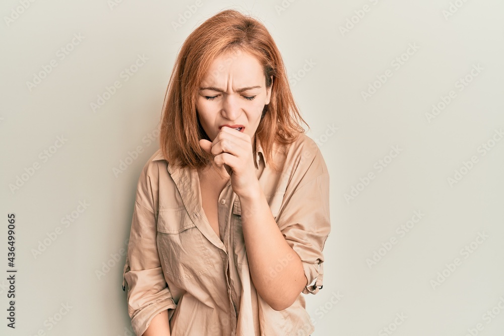 Young caucasian woman wearing casual clothes feeling unwell and coughing as symptom for cold or bronchitis. health care concept. Young caucasian woman wearing casual clothes feeling unwell and coughing as symptom for cold or bronchitis. health care concept.
