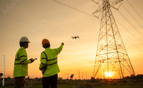 Two electrical engineers used drones to observe the planning work, producing electric power at high voltage electrodes photo