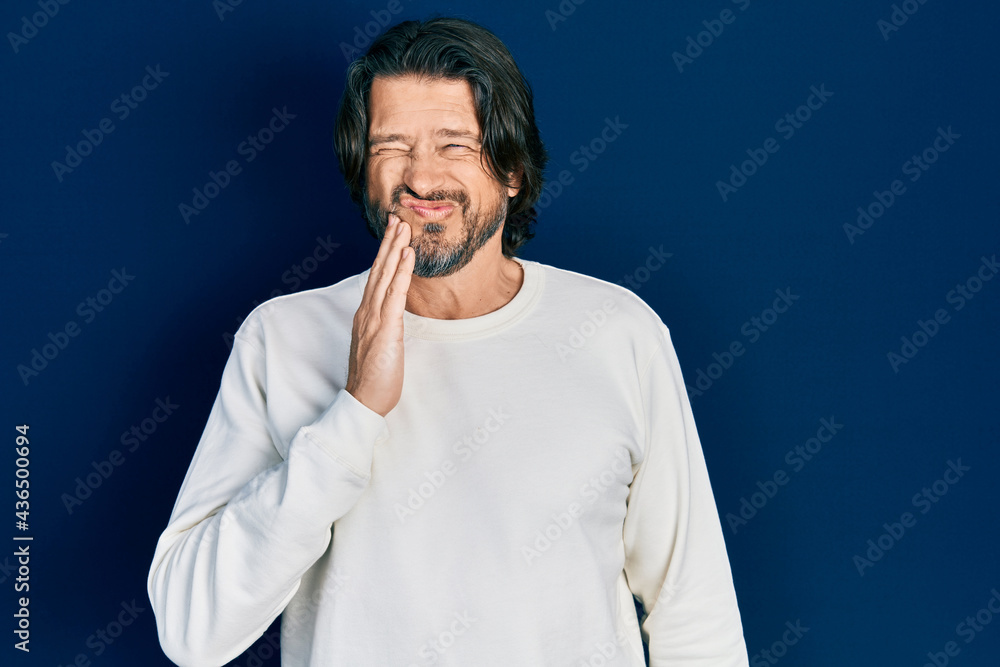 Middle age caucasian man wearing casual clothes touching mouth with hand with painful expression because of toothache or dental illness on teeth. dentist Middle age caucasian man wearing casual clothes touching mouth with hand with painful expression because of toothache or dental illness on teeth. dentist