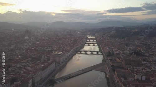 drone flying above the florence roofs, rivers and bridges with panoramic view