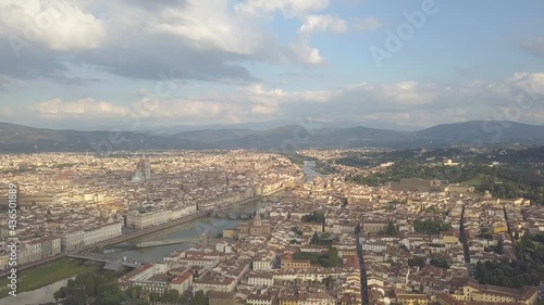 drone flying down above the florence roofs, rivers and bridges with panoramic view