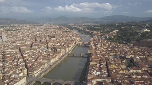 drone flying above the florence roofs, rivers and bridges with panoramic view