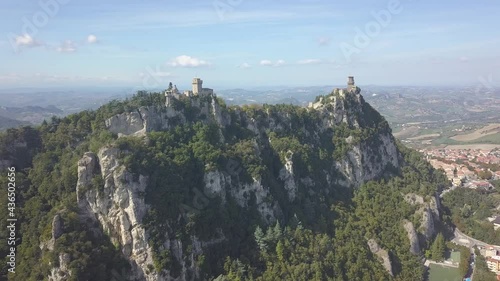 drone flying panoramic right around the san marino towers at the top of the mountain  in Italy