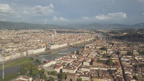 drone flying above the florence roofs, rivers and bridges with panoramic view