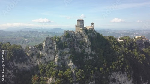 drone flying panoramic right and up around the san marino towers at the top of the mountain  in Italy