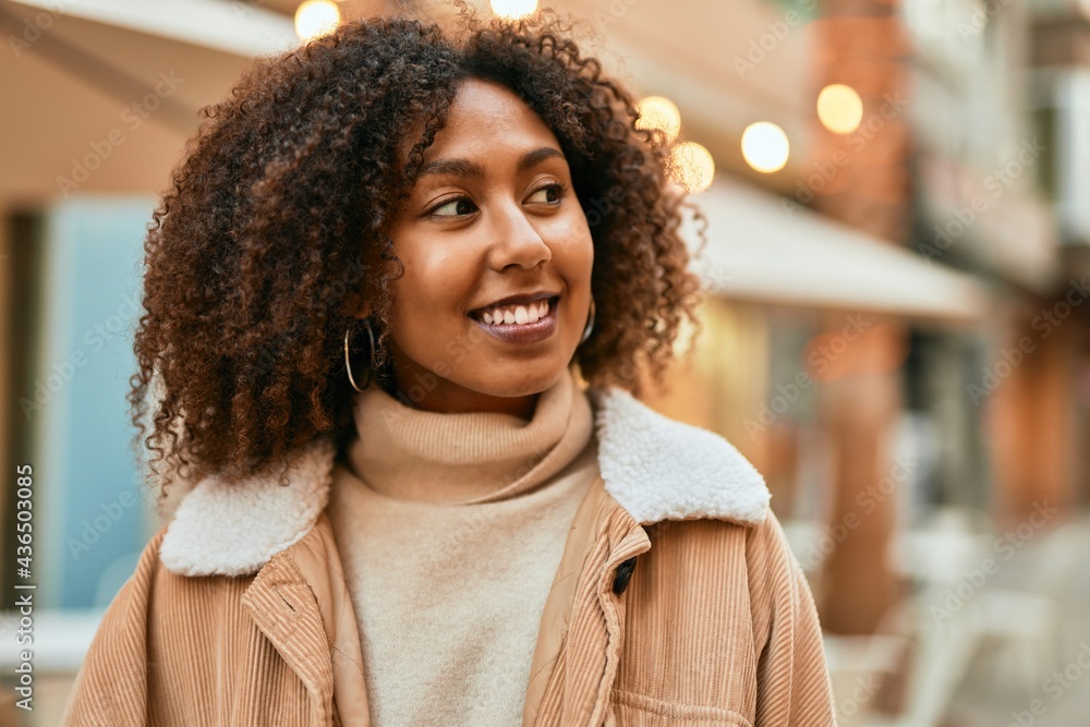 Young african american woman smiling happy standing at the city. Young african american woman smiling happy standing at the city.