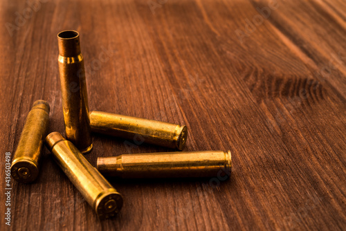 Empty shells from the rifle lying on a wooden table