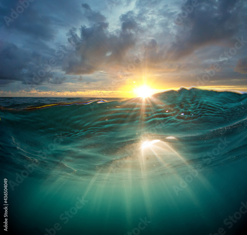 Fototapeta Naklejka Na Ścianę i Meble -  ocean in sunset light with Water line underwater sunrays