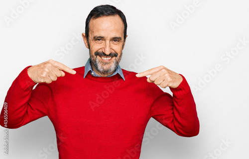 Middle age hispanic man wearing casual clothes looking confident with smile on face, pointing oneself with fingers proud and happy.