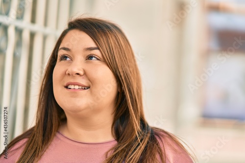 Free Download Young hispanic plus size woman smiling happy standing at the city. - GFXLoad