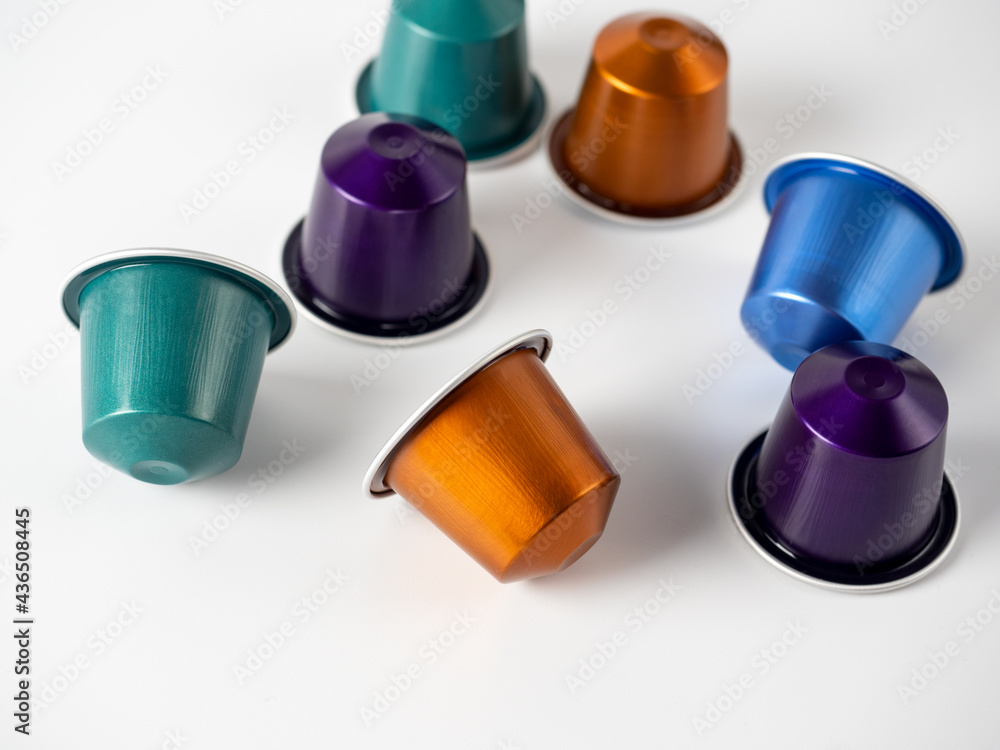Obraz premium Colorful aluminum capsules with ground coffee on a white background. Capsules for the coffee machine