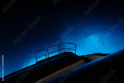 super yacht at night with blue underwater lights 