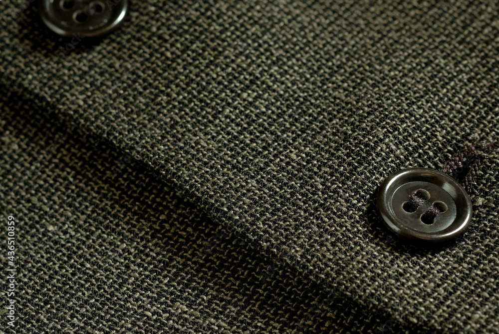 Buttons with holes, loops.Texture of textile fabric weaving.Details of the design of the men's vest.Close-up.Decorative elements.Sewing product design. Buttons with holes, loops.Texture of textile fabric weaving.Details of the design of the men's vest.Close-up.Decorative elements.Sewing product design.