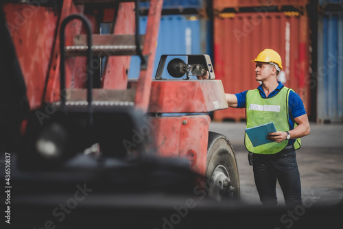 engineer foreman working in container terminal in term of industry logistic cargo shipping to export and import, warehouse delivery business freight transport, loading control in port with safety