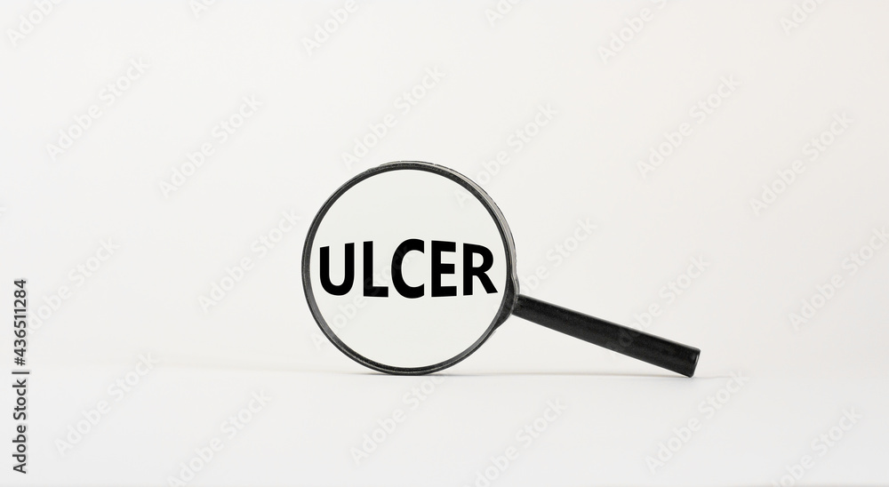 Medical and ulcer symbol. Magnifying glass with the concept word ulcer on beautiful white background. Medical and ulcer concept, copy space. Medical and ulcer symbol. Magnifying glass with the concept word ulcer on beautiful white background. Medical and ulcer concept, copy space.