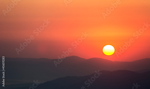 misty mountain silhouettes during sunset sunrise 