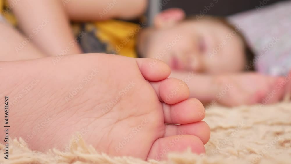 Close-up of the foot of a little boy sleeping on a bed Close-up of the foot of a little boy sleeping on a bed