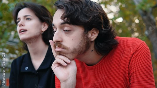 chatty young woman - guy with his face bored by his friend's chatter photo