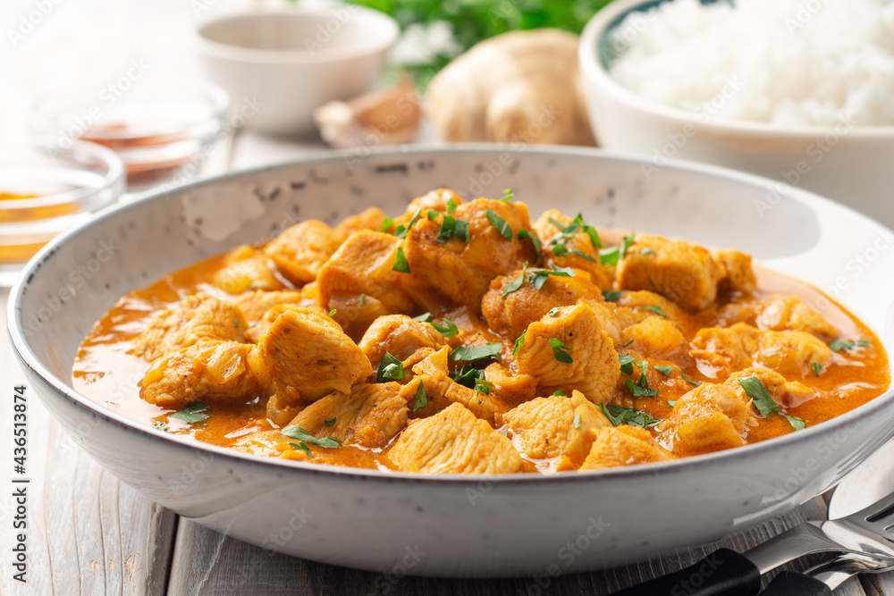 Chicken curry in plate on wooden background