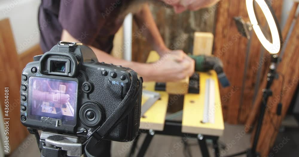 DIY woodworking vlogging, man drawing cutting marking lines, making wood block clock, filming using smartphone with led ring-light and dslr, focus on camera screen, close-up DIY woodworking vlogging, man drawing cutting marking lines, making wood block clock, filming using smartphone with led ring-light and dslr, focus on camera screen, close-up
