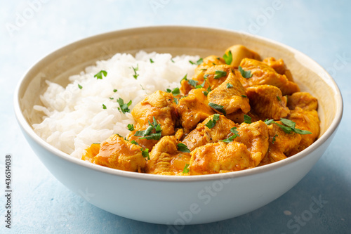 Chicken curry with rice in bowl on concrete background