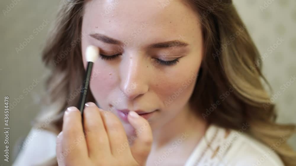 A beautiful girl with long hair do eye makeup. A beautiful girl with long hair do eye makeup.