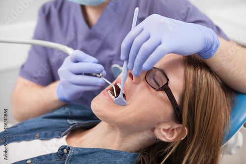 Close up of a female patient having dental treatment done by professional dentist