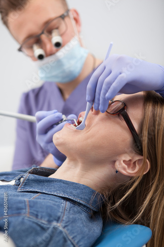 Vertical cropped close up of a female patient having dental checkup at dental clinic