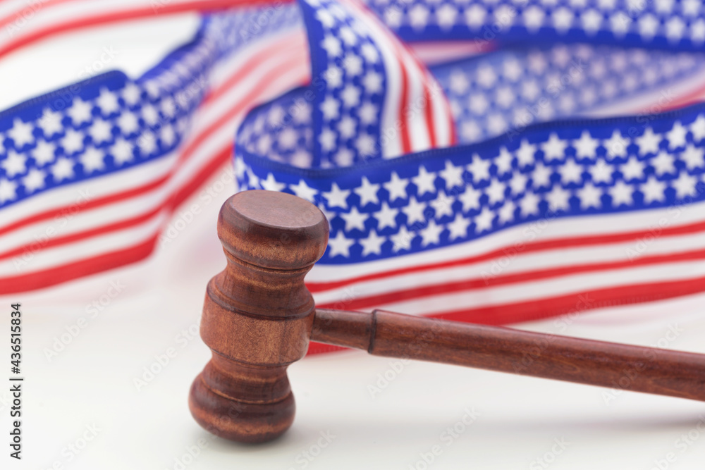 Gavel with Stars and Stripes Ribbon on white background reflect American justice system and democracy