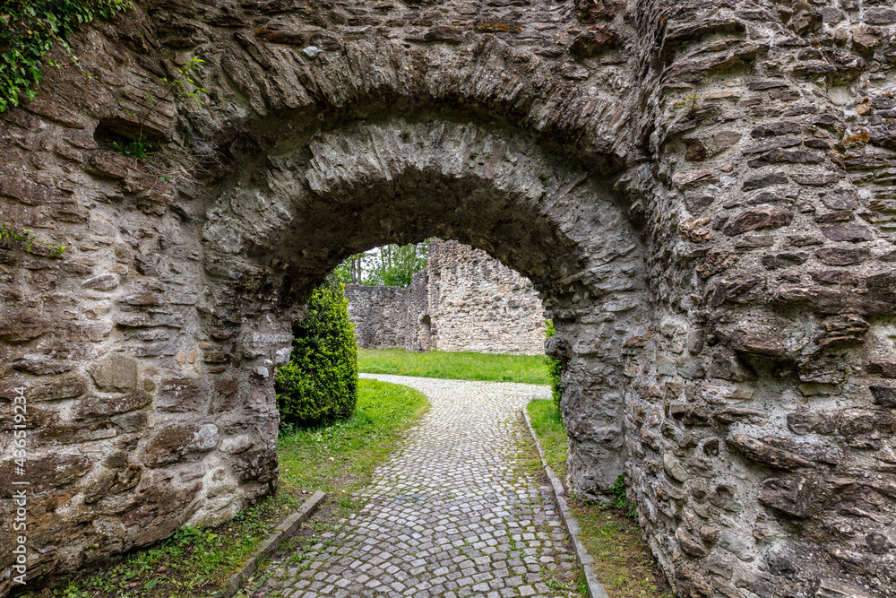 old stone arch in the garden, stone walls of a castle