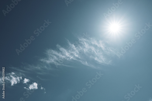 Sun in the sky with cirrus clouds