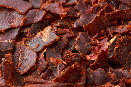 Dried Beef Jerky snack background, macro photo