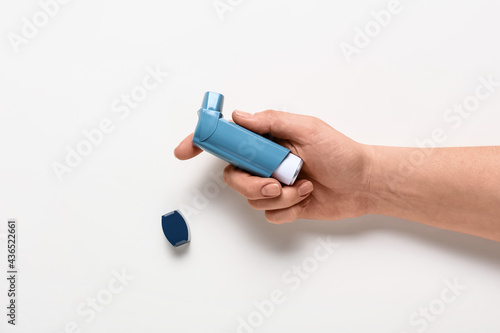 Hand holding blue asthma in...