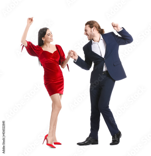 Happy young couple dancing on white background